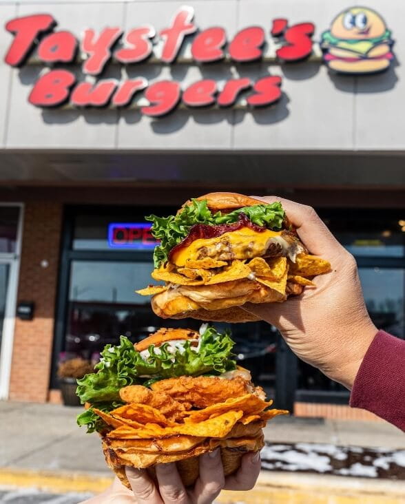 Holding a Burger in front of Taystee's Burgers